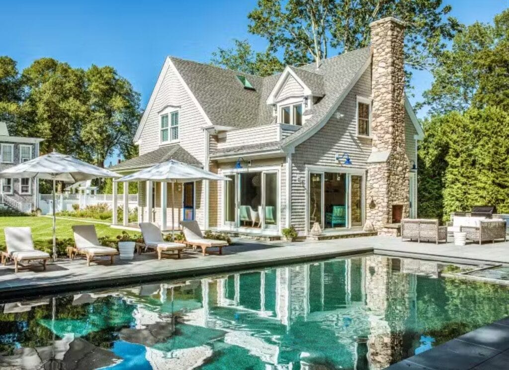 Cape Cod home addition with a luxury backyard guest house and pool