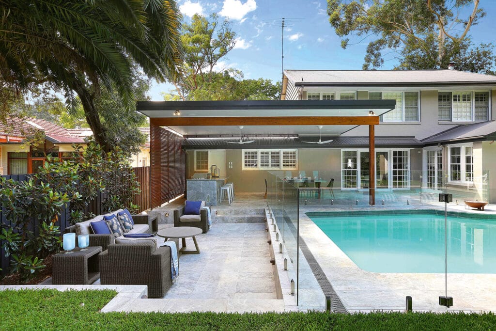 Resort-style outdoor living area with pool and modern deck, used in vacation rental upgrades Cape Cod homes