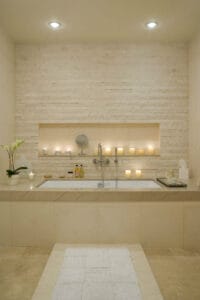 Spa-inspired bathroom with candles and soaking tub, perfect for vacation rental upgrades Cape Cod properties use to attract luxury bookings
